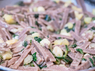 Close up of the succulent and typical Italian dish Pizzoccheri. Typical dish from Valtellina, Lombardy, Italy.