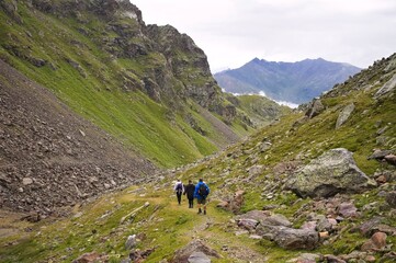 Fototapeta premium A group of people is hiking a mountain on the italian Alps (Trentino, Italy, Europe)