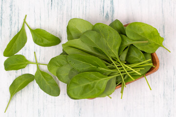 Baby spinach leaves in wooden bowl