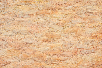 Plaster on a orange wall. Concrete wall texture close up.