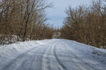 Countryside road in winter. The curving asphalt road in winter