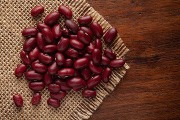 macro Close-up of Organic Rajma,  (Laal Lobia ) or red kidney beans dal cleaned on Jute mat and wooden top.
