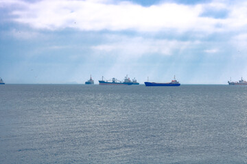 Cargo ships waiting on the sea to passing a canal or strait