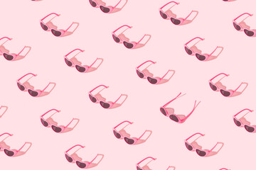 Minimal pattern made of pink sunglasses with sunlight shadow on pastel pink background. Creative summer concept.