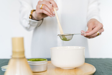 Female preparing matcha tea at home