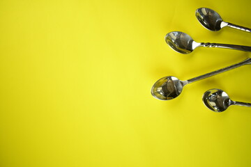 sliver wares spoon and fork on bright background