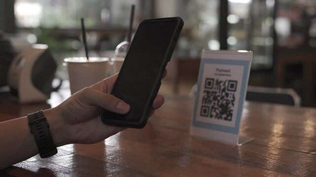 Man are scanning the QR code to order food. Online payment is an additional payment method for customers. Mobile scanning system online for pay money and protect virus.