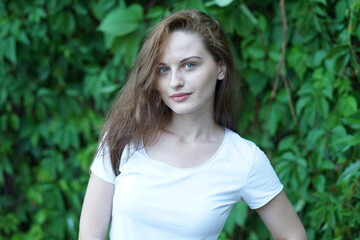 Fototapeta premium Portrait of a young beautiful girl in the park