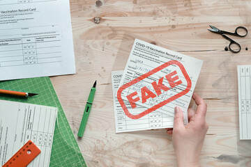 Fake covid vaccination record card. Forgery of health certificate confirming vaccinations against...