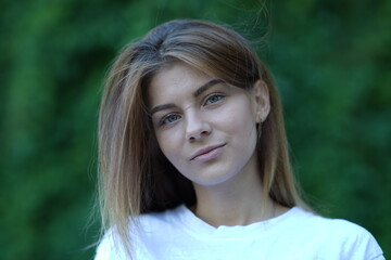 Portrait of a young beautiful girl in the park