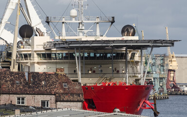 SHIP IN SEAPORT - Specialized watercraft moored at the wharf against the background of old...