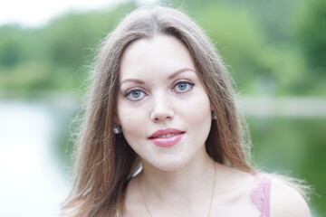 Portrait of a young beautiful girl in the park