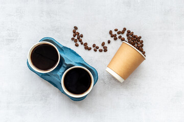 Paper coffee cups with coffee beans. Top view