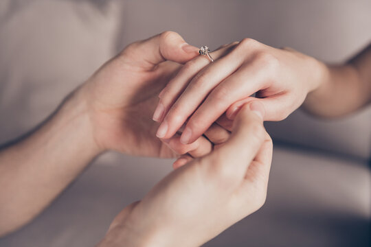 Cropped Close-up View Of Hands Girl Receiving Ring From Guy Fiance Propose Moment Finger At Home Indoors