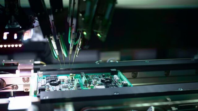 Production of electronic circuit boards. Machine for automatic installation of components on an electronic board. Manufacturing of microcircuits and microprocessors. The transistors are installed.