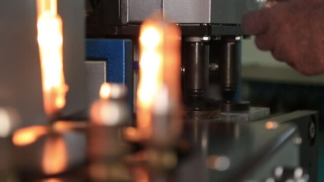 takes the pet preform from the oven and blows out the bottles. production of plastic bottles
