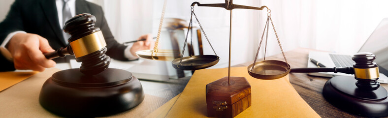 Business and lawyers discussing contract papers with brass scale on desk in office. Law, legal services, advice, justice and law concept picture with film grain effect