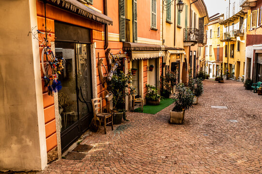 Beautiful street in the historic center of Luino with shops, plants and flowers