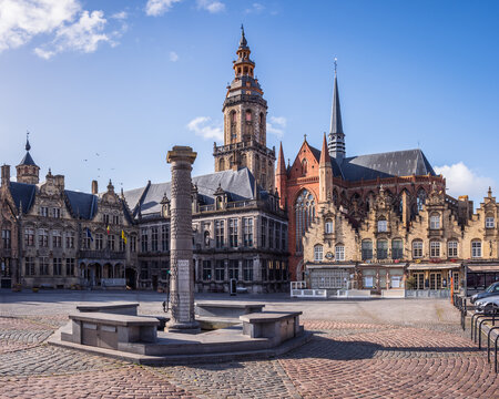 Veurne, West Flanders, Belgium - 04 06 2021: View of the market square (Grote Markt), the city hall,  the belfry, and the church of Saint Walburga