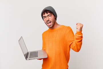 nerd man with computer shouting aggressively with an angry expression or with fists clenched...
