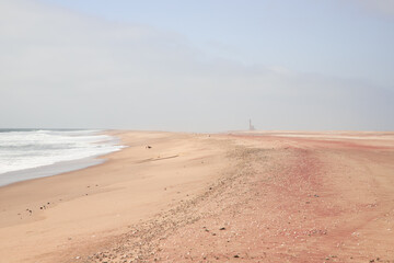 lighthouse on the background of pink sand