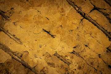 texture or background of old destroyed clay wall with wood inserts 
