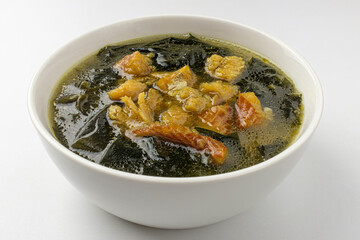 Yellow pollack seaweed soup on white background