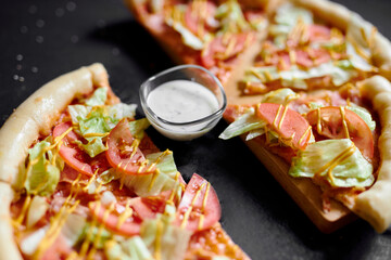 fresh pizza with salad, tomatoes and cheese board