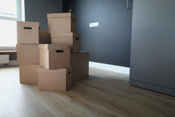 Cardboard boxes in empty room. Services of transport and logistics company