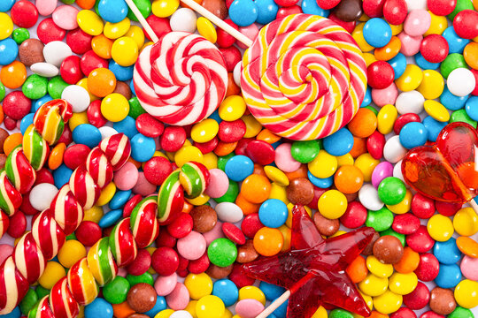 Colorful lollipops and different colored round candy.