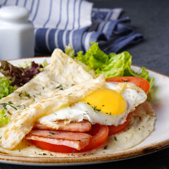Fototapeta na wymiar Omelet with fried egg, bacon and tomatoes. Morning Breakfast concept