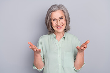 Photo of happy excited positive good mood mature woman talking communicating isolated on grey color...