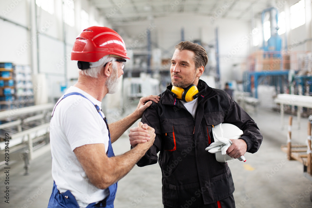 Wall mural portrait of workers in factory. colleagues with helmet working in factory.