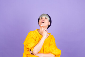 Stylish european woman on purple  background thinking worried looking aside concerned