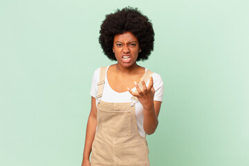 afro woman looking angry, annoyed and frustrated screaming wtf or what’s wrong with you chef...