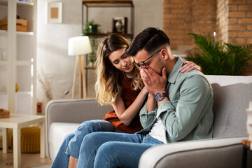 Obraz premium Young man having a problem. Girlfriend comforting her sad boyfriend