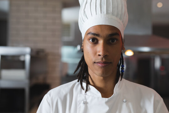 Portrait of mixed race professional chef wearing chefs hat