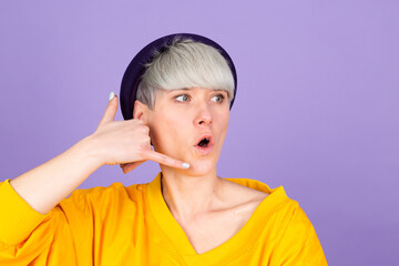 Stylish european woman on purple background smiling doing phone gesture with hand and fingers like talking on the telephone