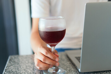 Man with glass of wine while working at home