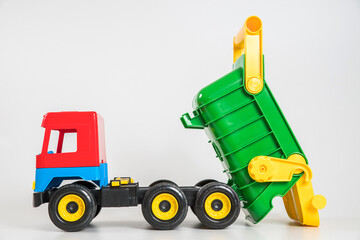 Multi-colored plastic children's toy cars on a white background. Truck.