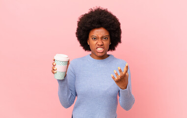 afro woman looking angry, annoyed and frustrated screaming wtf or what’s wrong with you. coffee...