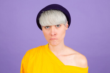 Stylish european woman on purple background sad upset unhappy emotions