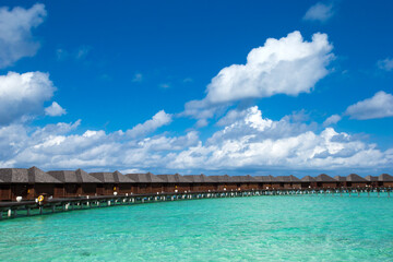 Beautiful tropical Maldives island with beach. Sea with water bungalows