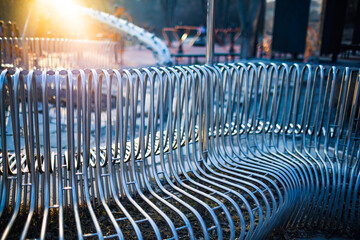 Close-up street bench metal pipes arranged parallel to each other on a street structure. Concept for weather resistant materials and modern industrial design. Advertising space