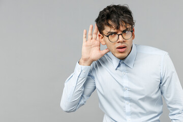 Young curious nosy employee business latin man 20s corporate lawyer wearing classic white shirt...