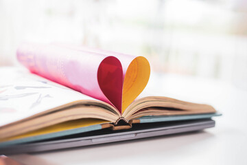 A heart shaped folded paper representing pink love