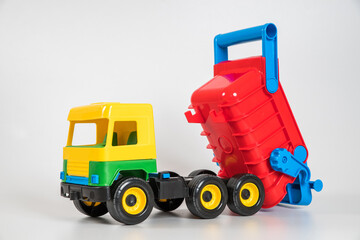 Naklejka premium Multi-colored plastic children's toy cars on a white background. Truck.