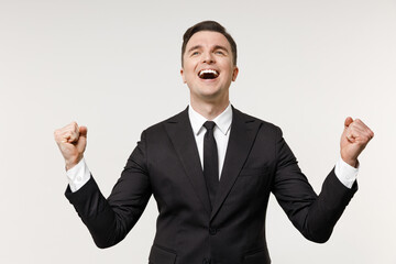 Young overjoyed excited employee business corporate lawyer man in classic formal black grey suit shirt tie work in office do winner gesture clench fist isolated on white background studio portrait