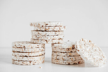 Round diet crispbreads on a white background. Round shaped cereal bread, healthy food without yeast. Copy, empty space for text