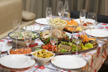 A beautiful served table for a holiday with a dish of baked fish.